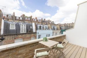 View from the refurbished Kensington mews residence towards its private roof terrace, connecting contemporary living spaces with the outdoors.